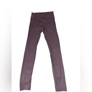 High waisted purple leggings with a zipper pocket on the back